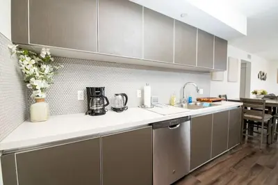 a kitchen with a sink and a counter top at Luxury 2Bed/2Bath Apt in West Hollywood w/ Rooftop in Los Angeles