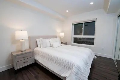 a white bedroom with a bed and a window at Luxury 2Bed/2Bath Apt in West Hollywood w/ Rooftop in Los Angeles