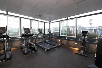 a gym with a row of treadms and cardio machines at Luxury 2Bed/2Bath Apt in West Hollywood w/ Rooftop in Los Angeles