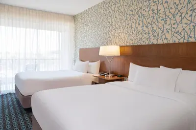 a hotel room with two beds and a window at Fairfield Inn & Suites by Marriott Los Angeles LAX/El Segundo in El Segundo