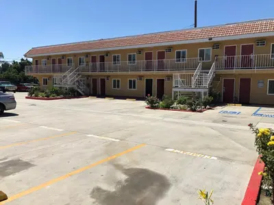 an empty parking lot in front of a motel at Glendora Motel in Glendora