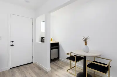 a white room with a table and a table and chair at Sunny Studio in the Heart of Venice - B in Los Angeles