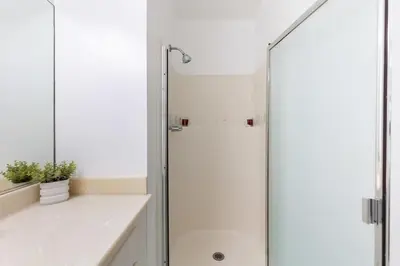 a shower with a glass door in a bathroom at Sunny Studio in the Heart of Venice - B in Los Angeles