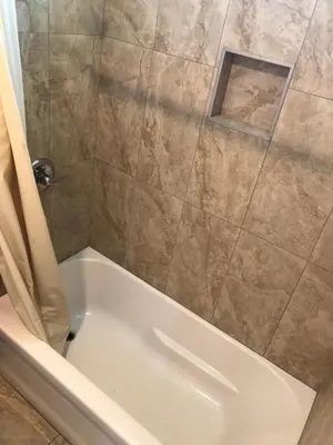 a bathroom with a shower with a white tub at Star Motel in Norwalk