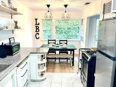 a kitchen with a table and a dining room at Beautiful Bright Condo Steps Away from the Beach in Long Beach