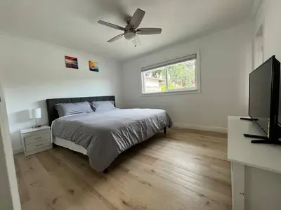 a bedroom with a bed and a flat screen tv at Modern 3 King Beds, Beautiful Large Backyard, WFH, Long Stays, Waterfall, WI-FI, FWY, 25 mins to Beach in Thousand Oaks