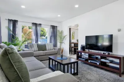 a living room with a couch and a flat screen tv at Modern Peaceful Private Oasis Near The Beach in Los Angeles
