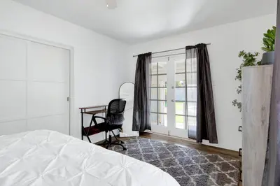 a bedroom with a bed and a desk and a window at Modern Peaceful Private Oasis Near The Beach in Los Angeles