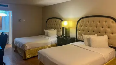a hotel room with two beds and a lamp at Motel 6 Victorville Green Tree Bvld in Victorville