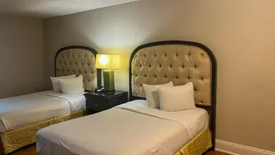 a hotel room with two beds and a lamp at Motel 6 Victorville Green Tree Bvld in Victorville