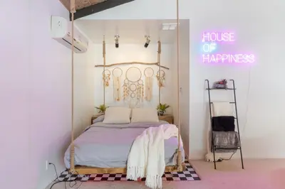 a bed in a room with a sign that reads house of happiness at Angel&Rose Universal Hollywood Heated Pool House King Bed in Los Angeles