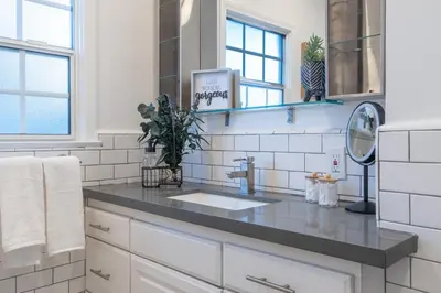 a white kitchen with a sink and a mirror at Angel&Rose Universal Hollywood Heated Pool House King Bed in Los Angeles