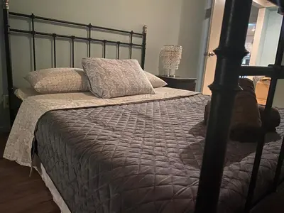 a bedroom with a bed with a black bed frame at Los Angeles Zen Home in Los Angeles