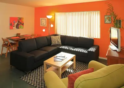 a living room with a couch and a table at Peninsula Hideaway Apartment • Alamitos Bay in Long Beach