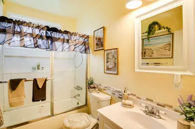 a bathroom with a toilet and a sink and a shower at Centrally Located Compton Retreat Patio and Grills in Compton