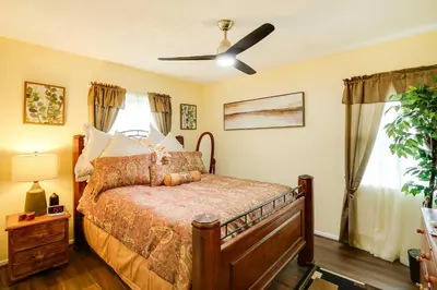 a bedroom with a bed and a ceiling fan at Centrally Located Compton Retreat Patio and Grills in Compton
