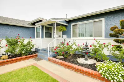a house with flowers in the front yard at Centrally Located Compton Retreat Patio and Grills in Compton