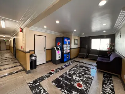a living room with a soda machine and a couch at The Patio Motel - Los Angeles, LAX in Gardena