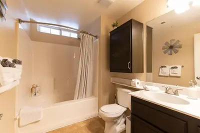 a bathroom with a sink and a toilet and a shower at Modern King Suite Deluxe Living Cali in Santa Clarita