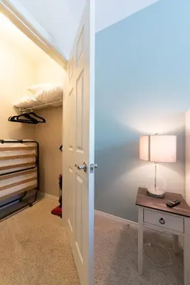 a bedroom with a closet and a table with a lamp at Modern King Suite Deluxe Living Cali in Santa Clarita