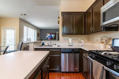 a kitchen with brown cabinets and a counter top at Saints 2BDRM King Suite Deluxe Living Cali in Santa Clarita