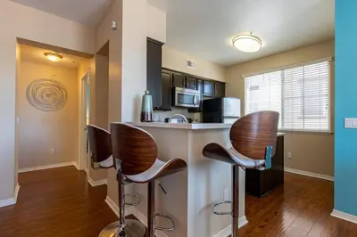 a kitchen with bar stools and a microwave at Sky Luxury 2BDRM Suite Deluxe Living Cali in Santa Clarita