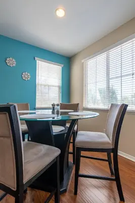 a dining room with a glass table and chairs at Sky Luxury 2BDRM Suite Deluxe Living Cali in Santa Clarita