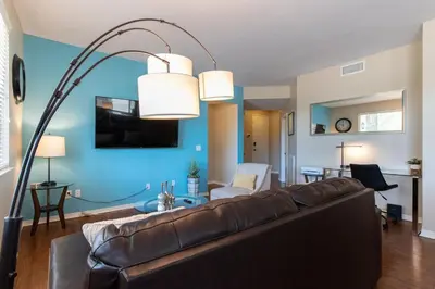 a living room with a brown couch and a blue wall at Sky Luxury 2BDRM Suite Deluxe Living Cali in Santa Clarita