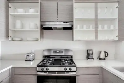 a kitchen with white cabinets and a stove top oven at North Hollywood 1br w roof terrace nr bars LAX-1130 in Los Angeles