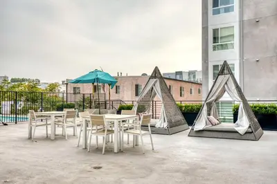 a patio with tables and chairs and an umbrella at North Hollywood 1br w roof terrace nr bars LAX-1130 in Los Angeles