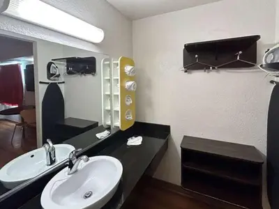 a bathroom with a sink and a mirror at Studio 6 Suites - Riverside, CA South in Riverside