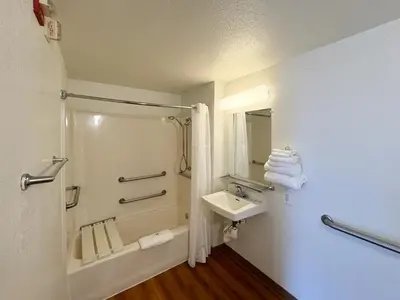 a bathroom with a shower and a sink and a mirror at Studio 6 Bellflower CA Los Angeles in Bellflower