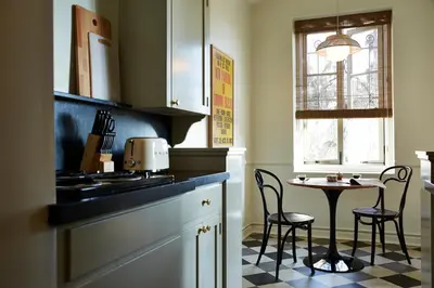 a kitchen with a table and chairs next to a window at Cozy Studio With Franklin Village View - 30 Day Minimum Stay in Los Angeles