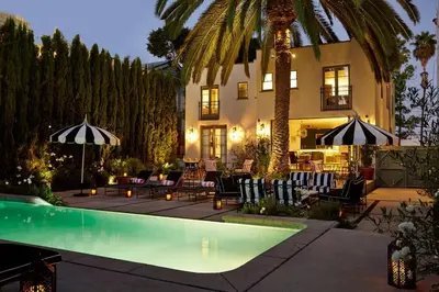 a house with a swimming pool in front of a building at Cozy Studio With Franklin Village View - 30 Day Minimum Stay in Los Angeles