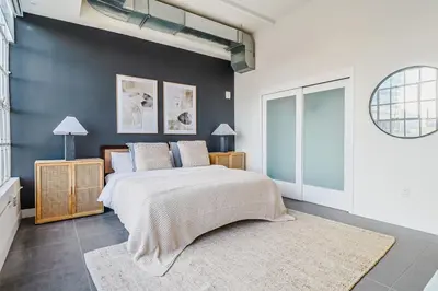 a bedroom with a bed and a blue wall at Sunny & Spacious 2BDR & 1BTH in Downtown LA in Los Angeles