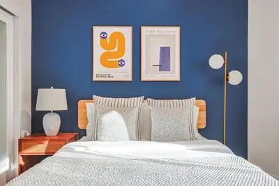 a bedroom with a blue wall with a bed at Sunny & Spacious 2BDR & 1BTH in Downtown LA in Los Angeles