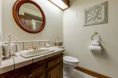 a bathroom with a sink and a toilet and a mirror at Mountain Memories on Tavern Bay in Lake Arrowhead