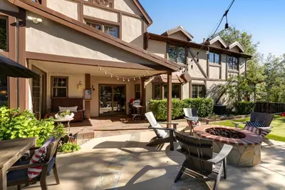a patio with a table and chairs and a fire pit at Mountain Memories on Tavern Bay in Lake Arrowhead