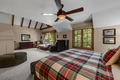 a bedroom with a bed and a ceiling fan at Mountain Memories on Tavern Bay in Lake Arrowhead