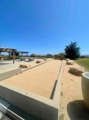 a long walkway with rocks and a park at Summer Lillie #3 in Summerland