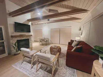 a living room with a couch and a table at Summer Lillie #3 in Summerland