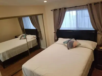 a bedroom with two beds and a large window at Beautiful Spacious 2 Bedroom, 2 Bathroom Condo in Long Beach