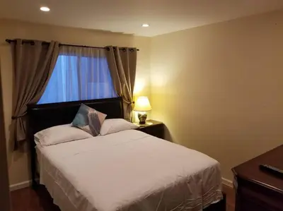 a bedroom with a white bed and a window at Beautiful Spacious 2 Bedroom, 2 Bathroom Condo in Long Beach