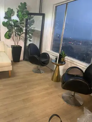 a living room with two chairs and a large window at Your Penthouse Ocean view with City lights and Queen Mary too in Long Beach