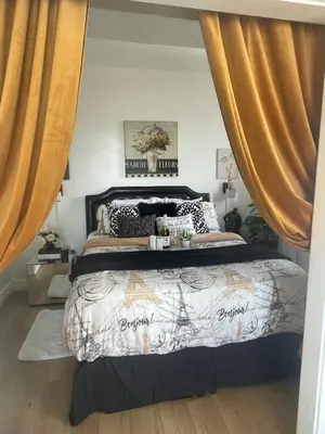 a bedroom with a large bed with curtains at Your Penthouse Ocean view with City lights and Queen Mary too in Long Beach