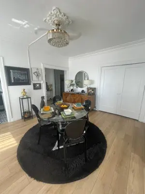 a dining room with a table and chairs in a living room at Your Penthouse Ocean view with City lights and Queen Mary too in Long Beach