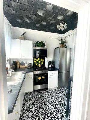 a kitchen with a black and white tile floor at Your Penthouse Ocean view with City lights and Queen Mary too in Long Beach