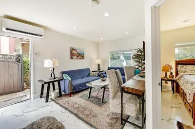 a living room with a blue couch and a table at Anaheim Hills Retreat - 17 Mi to Disneyland! in Anaheim