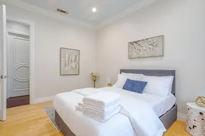 a white bedroom with a large bed with towels on it at Regal 4 bed with hot tub close to Universal sleeps 15 in Los Angeles