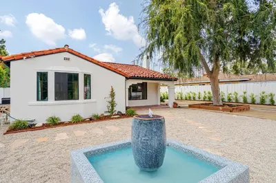 a house with a fountain in the middle of a yard at Designer 2 bed near Universal sleeps 8 hot tub in Los Angeles